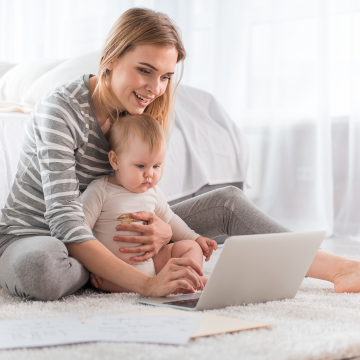 Mother with baby looking at a laptop