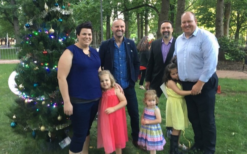 Red Nose Puggles Playgroup Coordinator Candy Van Poppel and her family assisting the Chief Minister to decorate the tree on the opening night of Christmas in Glebe Park