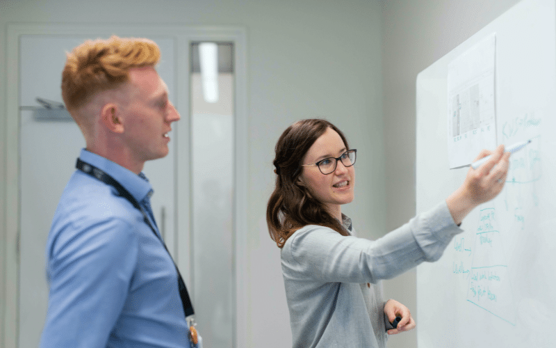 A man and a women in the office working together