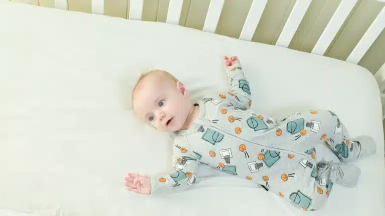 Baby on their back in a safely setup cot