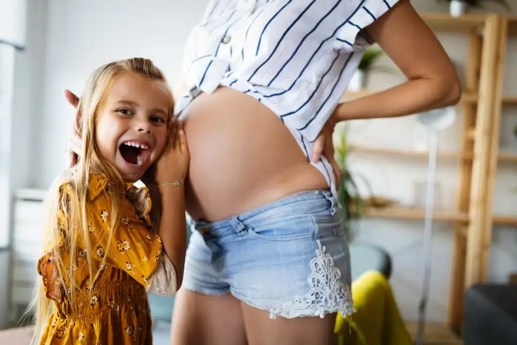 happy pregnant mum and daughter