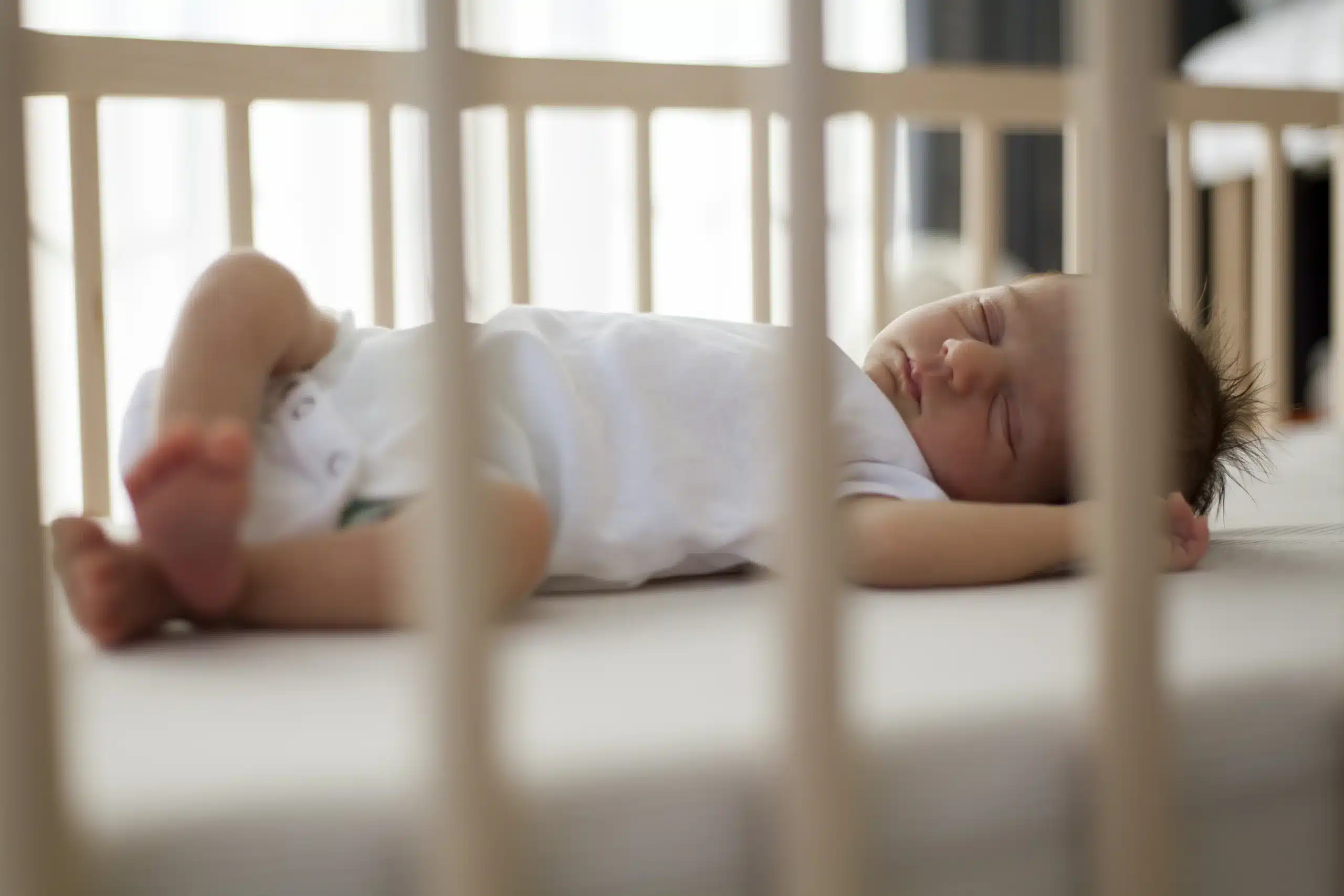 baby sleeping in safe cot