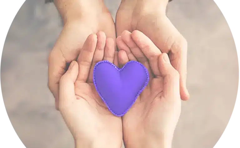 Two hands holding a purple heart.