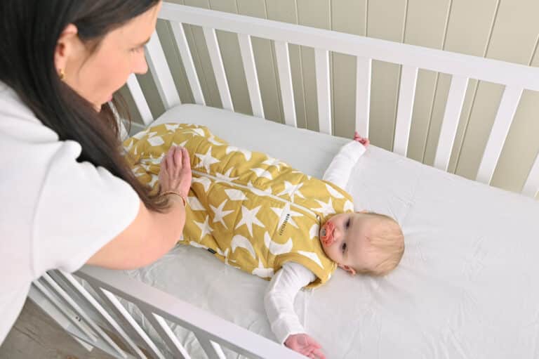 Baby lying down in cot