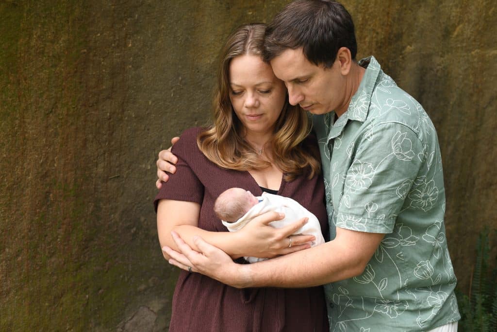Jess and her husband Josh holding Josiah